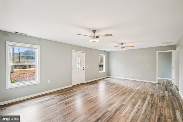 interior space with ceiling fan and wood-type flooring