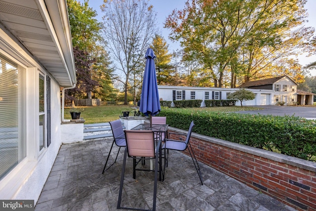 view of patio featuring an outbuilding and a garage