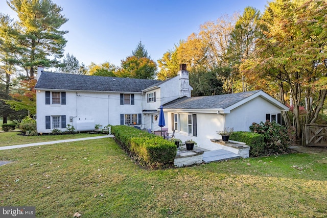 rear view of property with a yard