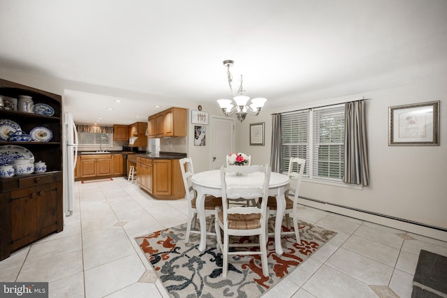 dining area featuring a baseboard radiator, light tile patterned floors, and a chandelier