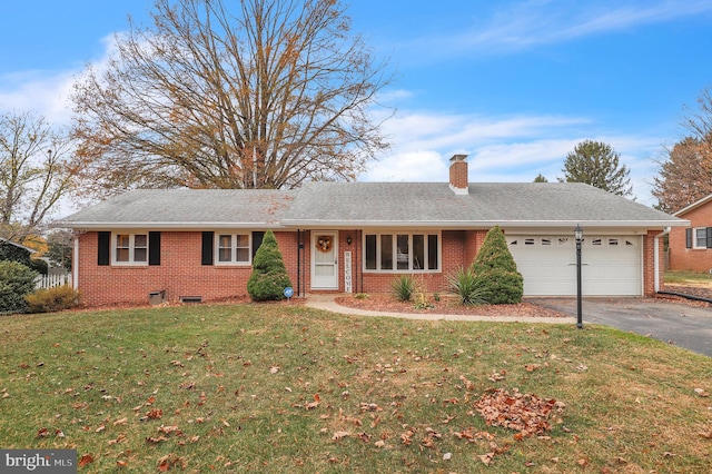 ranch-style house featuring a garage and a front lawn