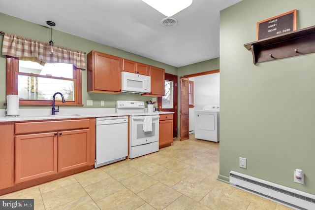 kitchen with a baseboard radiator, a healthy amount of sunlight, white appliances, decorative light fixtures, and washer / dryer