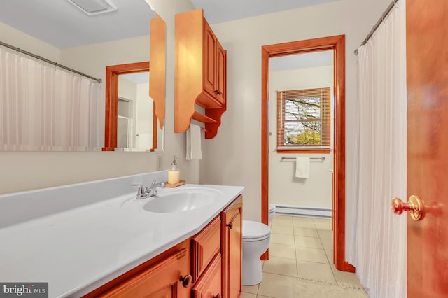 bathroom with a baseboard heating unit, tile patterned flooring, vanity, and toilet