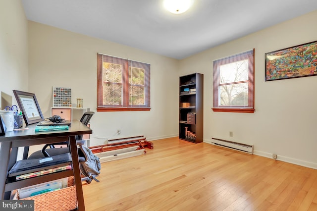 office featuring a baseboard heating unit and wood-type flooring