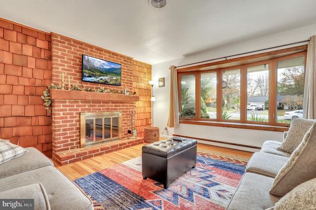 living room with hardwood / wood-style floors and a fireplace