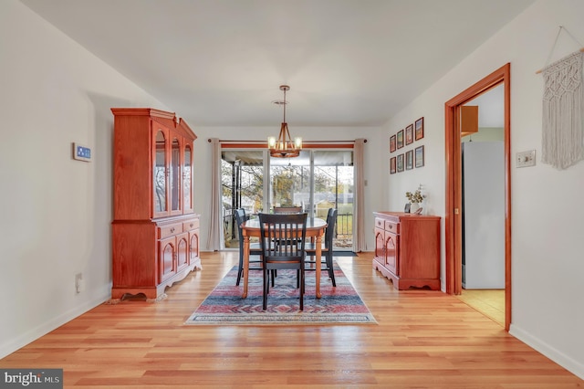 dining area featuring a notable chandelier and light hardwood / wood-style flooring