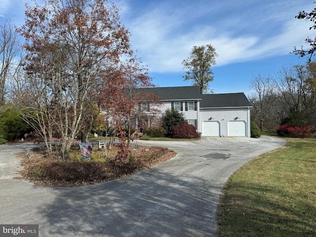 view of front of property with a garage and a front lawn