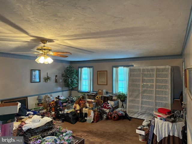 carpeted bedroom featuring ornamental molding, a textured ceiling, and ceiling fan