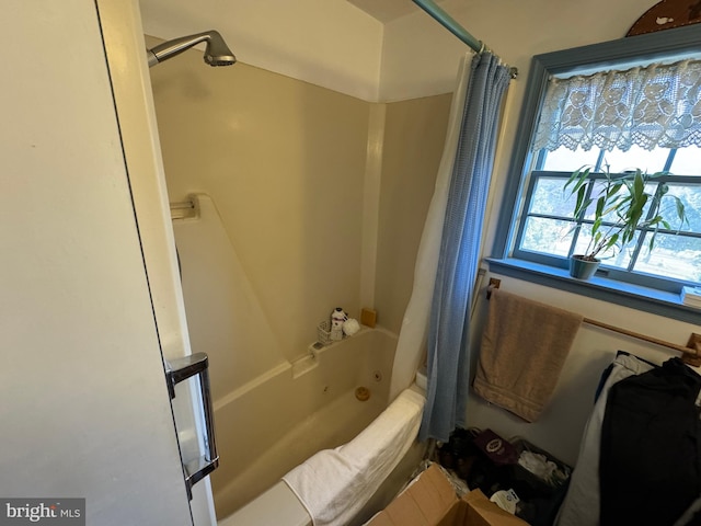 bathroom featuring shower / bathtub combination with curtain