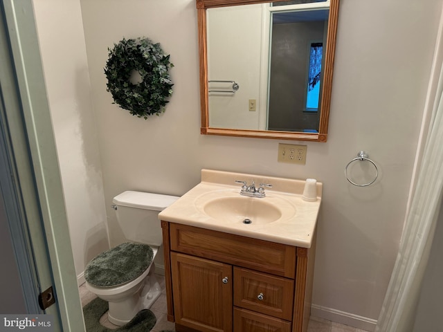 bathroom featuring vanity, tile patterned flooring, and toilet