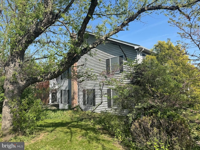 view of home's exterior with a lawn