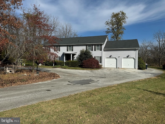 view of front of property featuring a garage and a front lawn