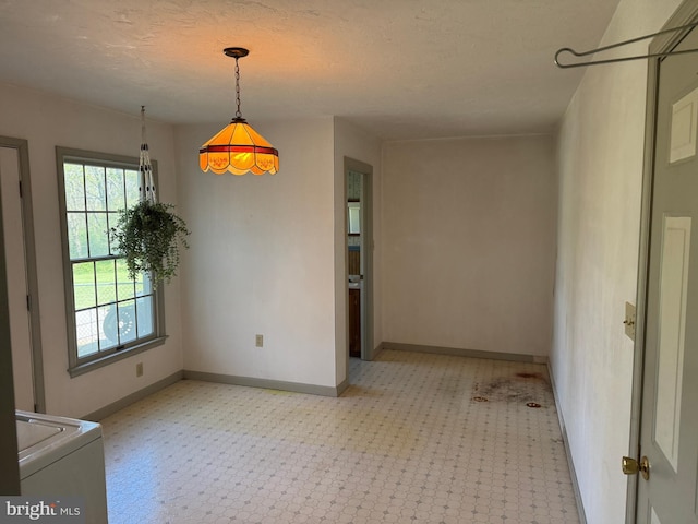 unfurnished dining area with baseboards