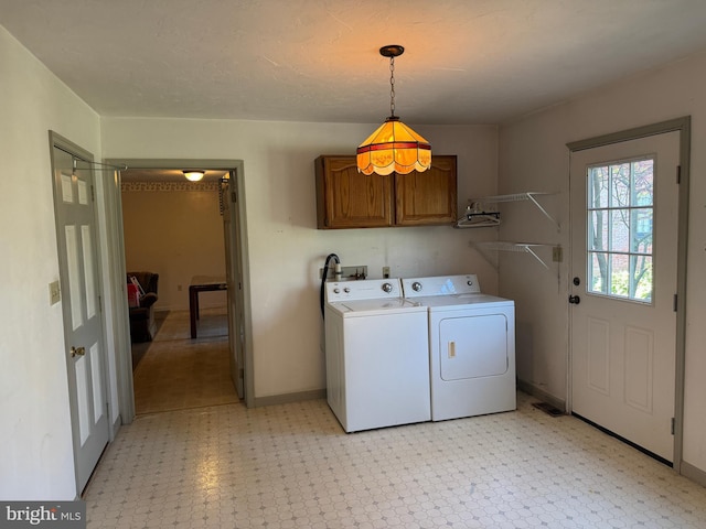 laundry area with light floors, cabinet space, baseboards, and independent washer and dryer
