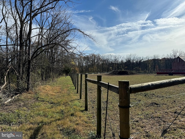 view of yard with a rural view