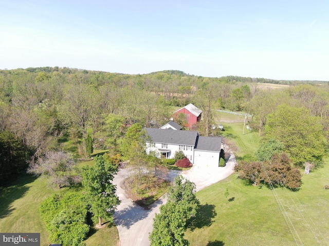 birds eye view of property featuring a wooded view