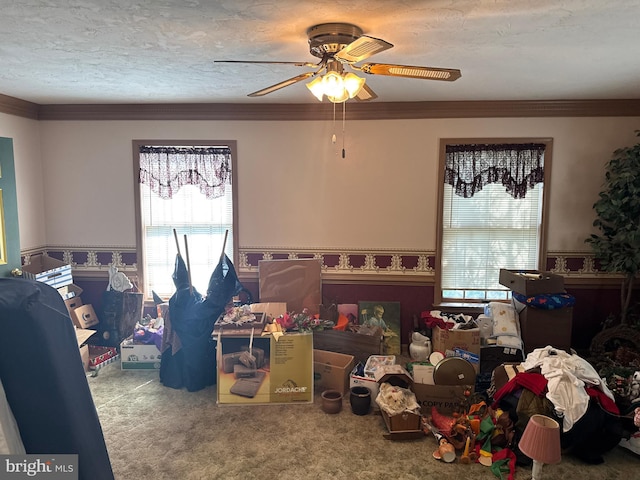 recreation room with ceiling fan, carpet flooring, and a healthy amount of sunlight