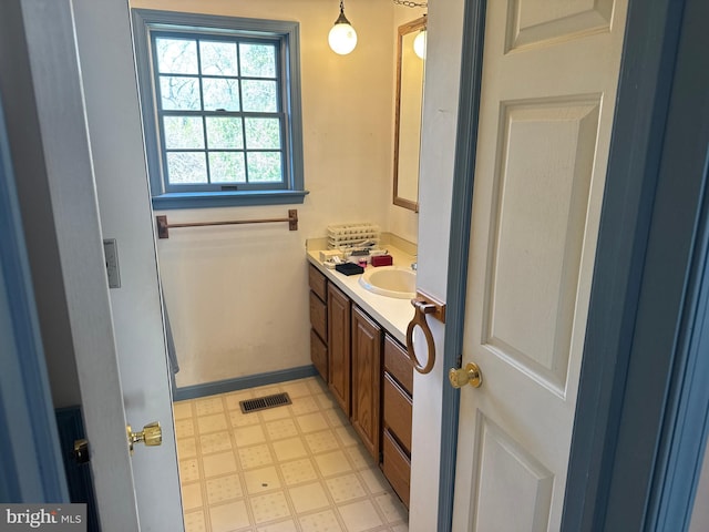 bathroom with baseboards, tile patterned floors, vanity, and visible vents
