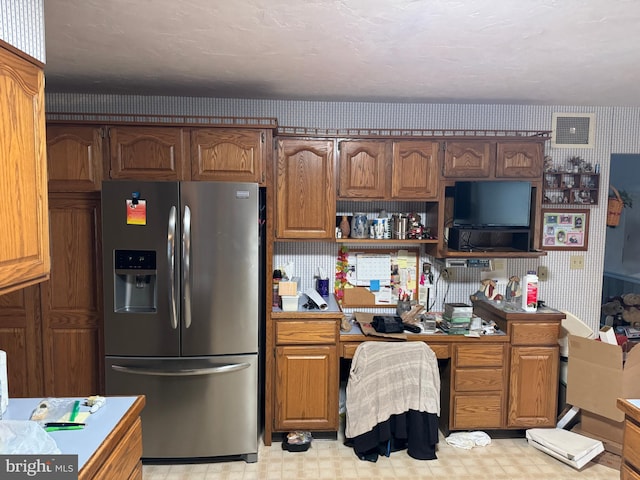 kitchen featuring stainless steel fridge with ice dispenser