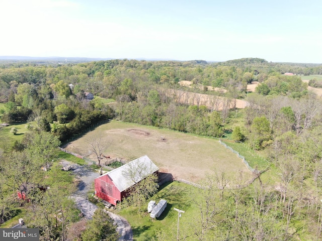 bird's eye view with a wooded view