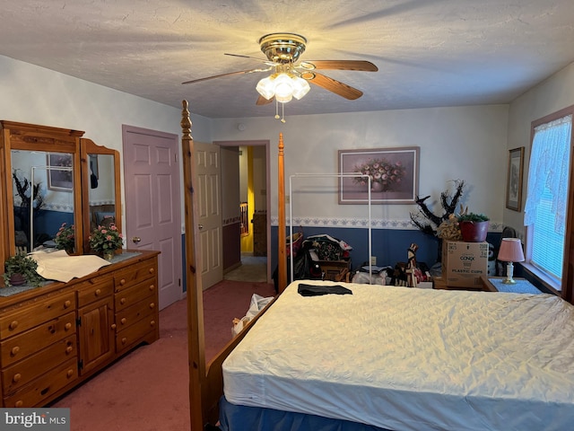 carpeted bedroom with multiple windows and ceiling fan