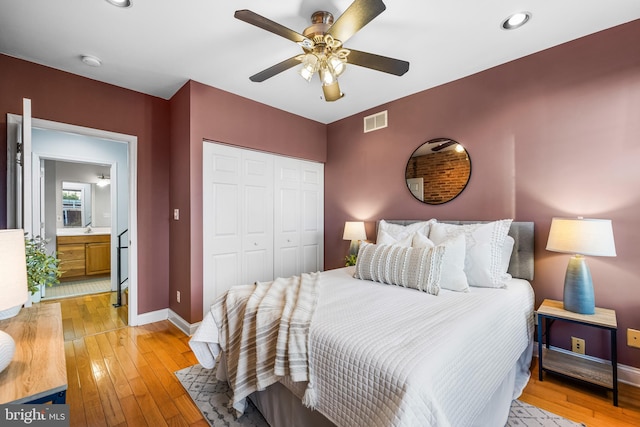 bedroom with a closet, ceiling fan, and light hardwood / wood-style floors