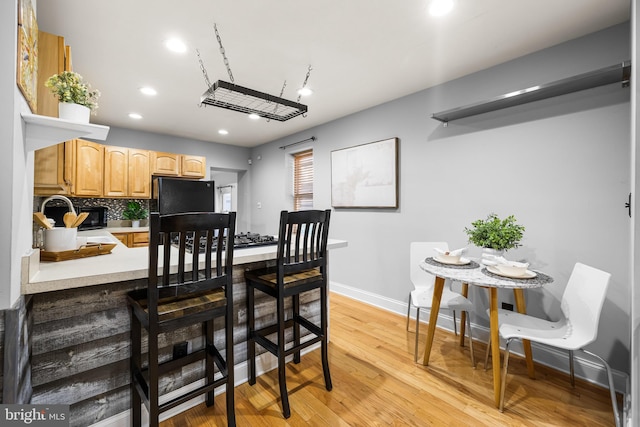 dining room featuring light wood-type flooring and sink