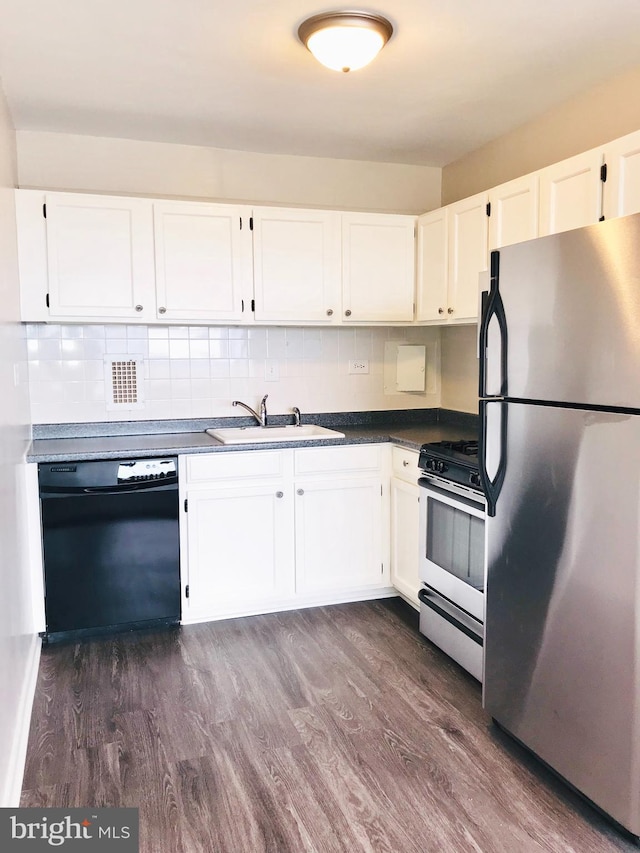 kitchen with gas range, black dishwasher, stainless steel fridge, sink, and white cabinets