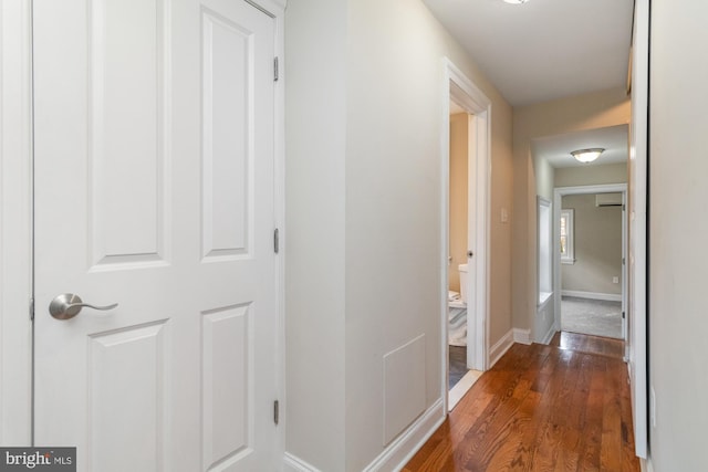 hallway with dark hardwood / wood-style flooring