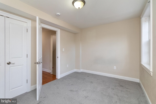 empty room featuring light colored carpet