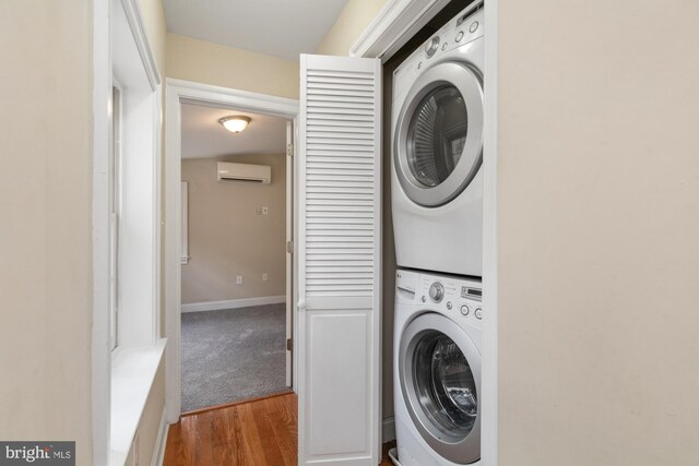 laundry area with stacked washer / dryer, light wood-type flooring, and an AC wall unit