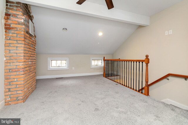 bonus room featuring carpet floors, vaulted ceiling with beams, and ceiling fan