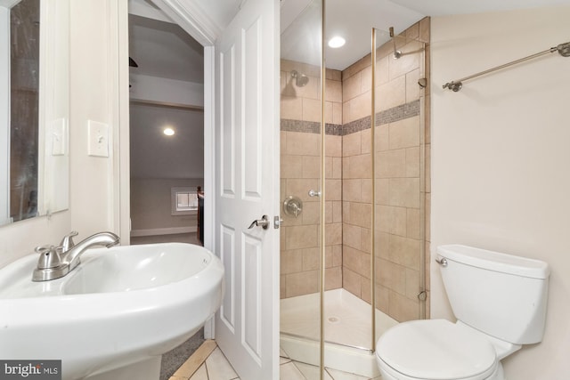 bathroom featuring walk in shower, tile patterned floors, toilet, and sink