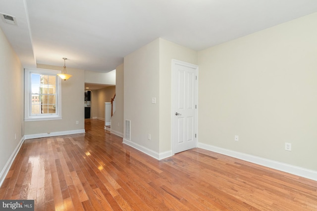 spare room with light hardwood / wood-style floors