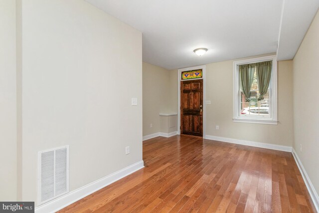 unfurnished room featuring hardwood / wood-style flooring