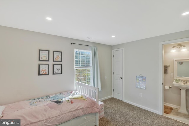 carpeted bedroom with connected bathroom