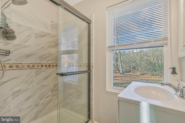 bathroom featuring sink and a shower with door