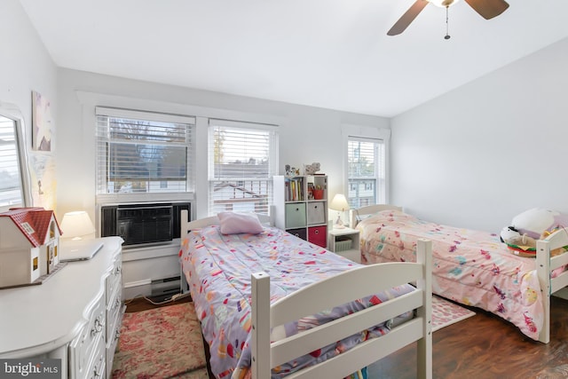 bedroom featuring multiple windows, ceiling fan, and dark hardwood / wood-style floors