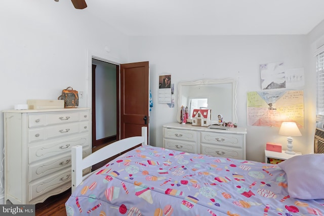 bedroom featuring vaulted ceiling, ceiling fan, and dark hardwood / wood-style flooring