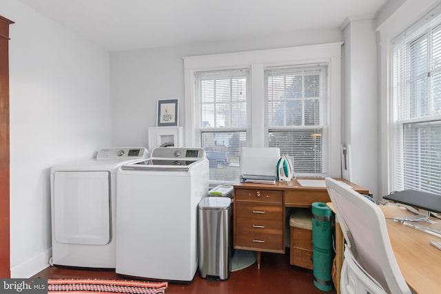 laundry room featuring dark hardwood / wood-style flooring, independent washer and dryer, and a healthy amount of sunlight