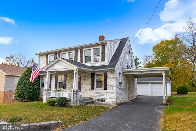 view of front of house with a front lawn, a garage, a carport, and a porch