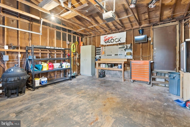 garage featuring a garage door opener and a workshop area