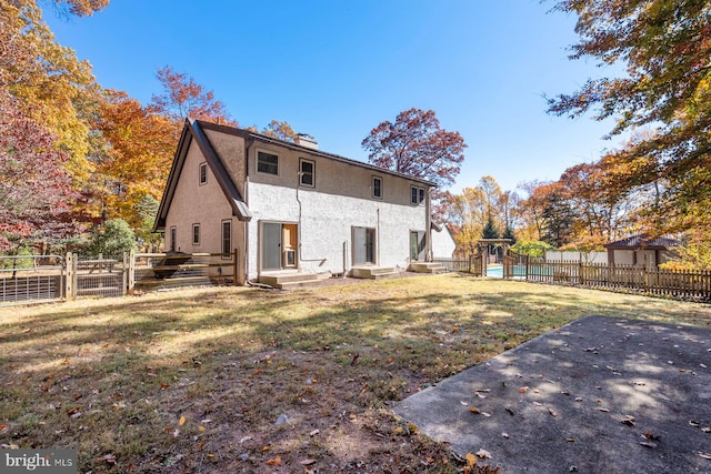 rear view of house featuring a lawn