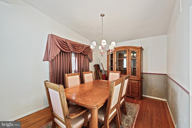 dining room with a chandelier and dark hardwood / wood-style floors