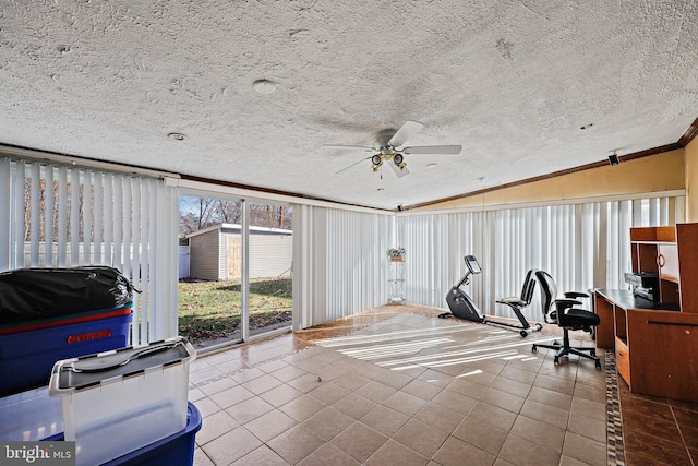 exercise room featuring a textured ceiling, crown molding, ceiling fan, and lofted ceiling