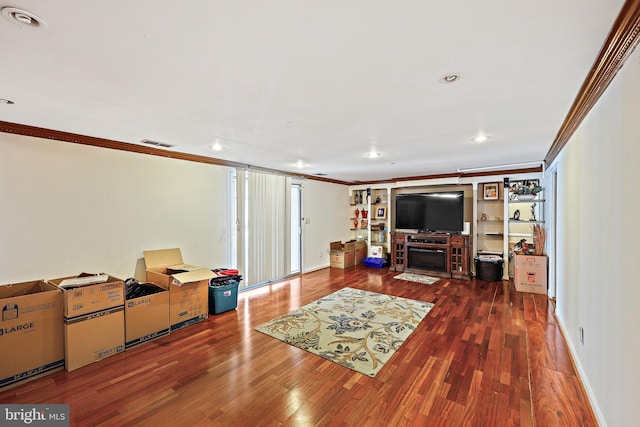 living room featuring a fireplace, dark wood-type flooring, and ornamental molding