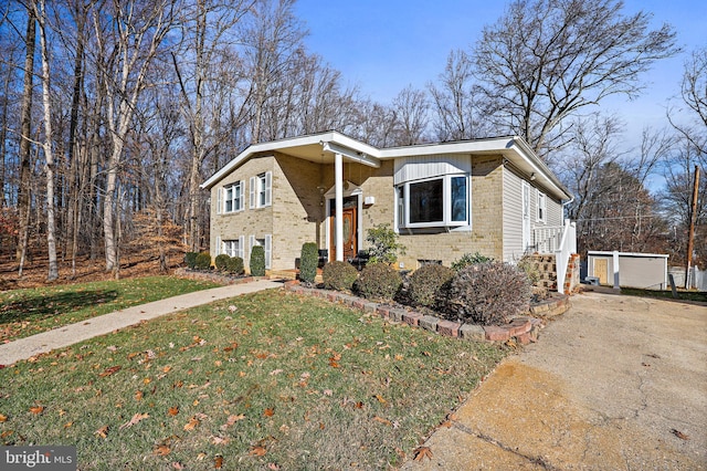 view of front facade with an outdoor structure and a front yard