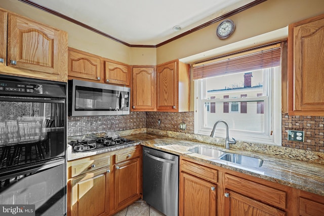 kitchen featuring decorative backsplash, light stone countertops, sink, and appliances with stainless steel finishes