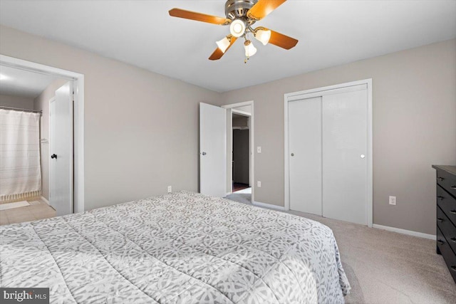 carpeted bedroom with ceiling fan, connected bathroom, and a closet