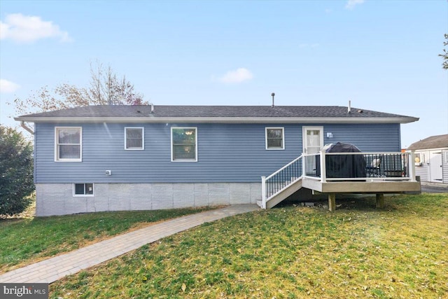 back of property featuring a yard and a deck